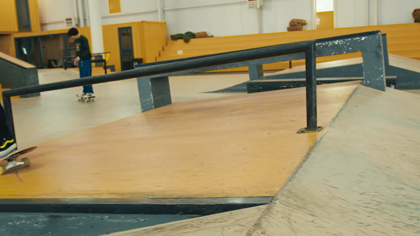 Young skater making jump, performing trick, skateboarder training in skatepark, making tricks, slides and flips, jump over the gap, professional extreme sport athlete ride on skateboard. 