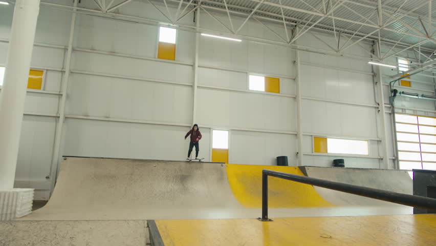 Young skater performing trick, skateboarder training in skatepark, making tricks, slides and flips, jump over the gap, professional extreme sport athlete ride on skateboard. 
