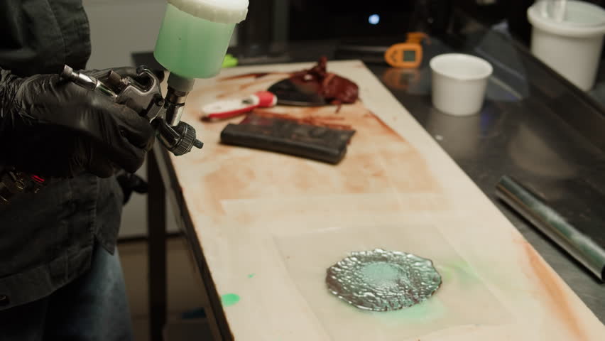 Woman chef confectioner making chocolate candy, pouring cacao for mousse pink cake, creamy dessert close-up gastro art. Restaurant dessert, sugar sweets, almond chocolate mousse.