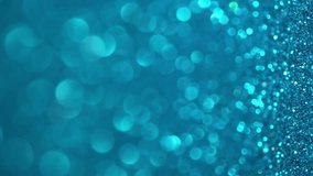 Blue Glitter Background. Magic dust, shiny texture, holiday lights, flying particles form a beautiful bokeh. Shining festive Christmas backdrop. Vertical Video