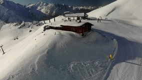 Aerial video of a cable car and people snowboarding and skiing in South Tyrol italy