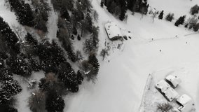 Aerial video of a people snowboarding and skiing