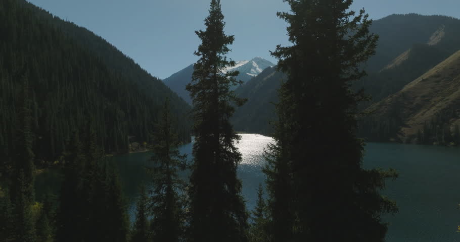 Kolsai Lake, Kazakhstan. Deep mountain lake Lake Kaindy sunken forest landmark in asia. Beautiful mountain nature landscape. Blue lake Kolsai top view. Panoramic view of the nature reserve. 