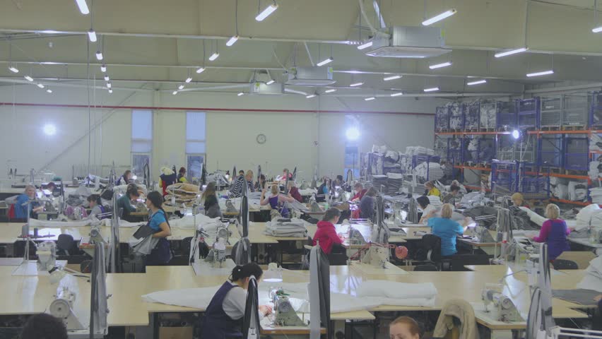 Large sewing production. There are many seamstresses in the workshop. Garment factory interior. Women in the sewing industry | Shutterstock HD Video #1103374491