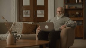 Senior Man on Video Call using Laptop, grandfather talking to family