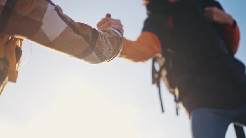 business. helping hand close-up business travel silhouette concept. group team climbers lends helping hand climb mountains helping hand. people tourists climb top overcoming hardships teamwork