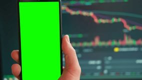 Black phone with blank mockup screen on rising stock graph. Closeup hand showing smartphone isolated green display. Online banking, Fund App use. Financial analyst on Invest Market. Bank collapse 2023 - Powered by Shutterstock - Get 15% off with code: PIKWIZARD15