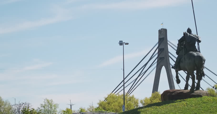 Panorama of the North Bridge, sculpture by Ilya Muromets in the park of Kyiv. Daytime, wide shot.
