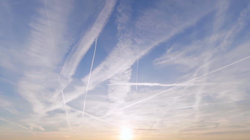 Unbranded military fighter jets flying overhead in a V-shaped formation at sunrise - seamless looping.