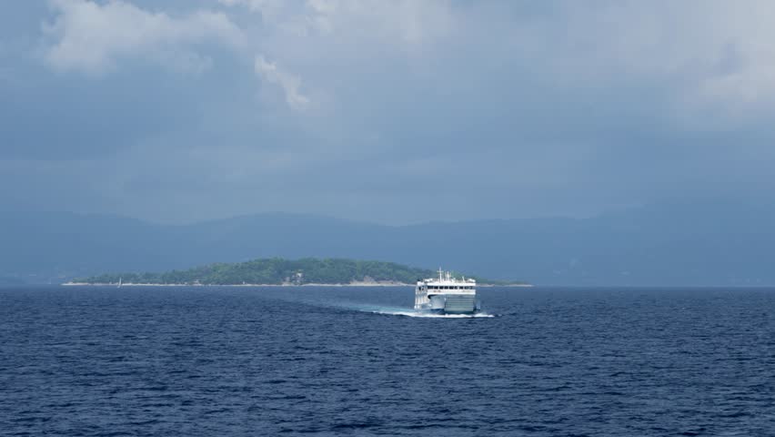 Ferry boat loaded with cars and trucks sail on sea