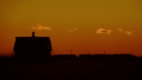 Silhouette of a splendid old country barn with a blazing orange sky just after sunset. - Powered by Shutterstock - Get 15% off with code: PIKWIZARD15