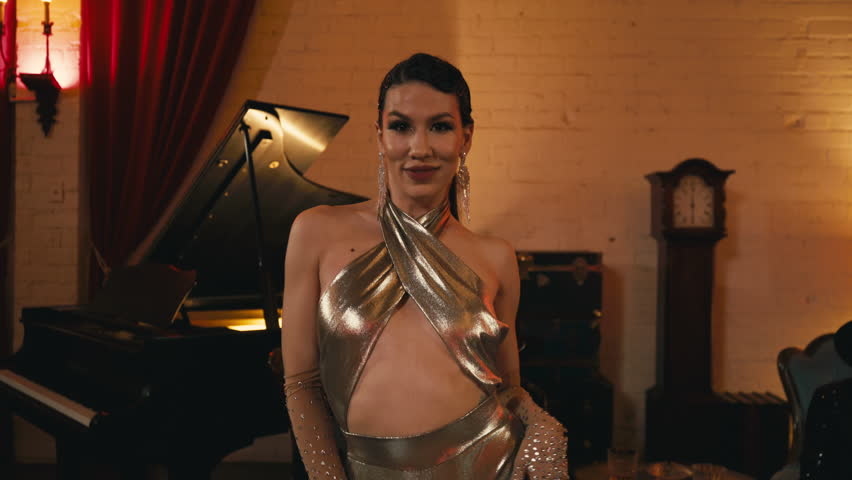 Closeup beautiful flirting asian woman and man dancing in Hollywood theatre interior. Glamorous couple making hand moves indoors. Asian professional dancer performing funk style sync moves dance 4K