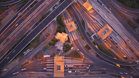 Interchange traffic time lapse showcases the bustling movement of vehicles at a junction, capturing the flow, congestion, and patterns in a visually engaging way. Timelapse. Aerial view. 4K HDR
