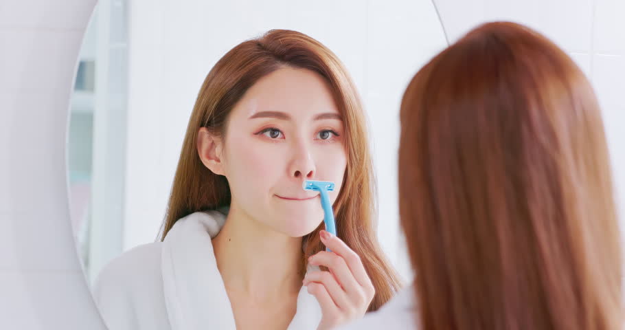asian woman shaving facial mustache with razor scratch and she hurt skin feel pain unhappy Royalty-Free Stock Footage #1103404321
