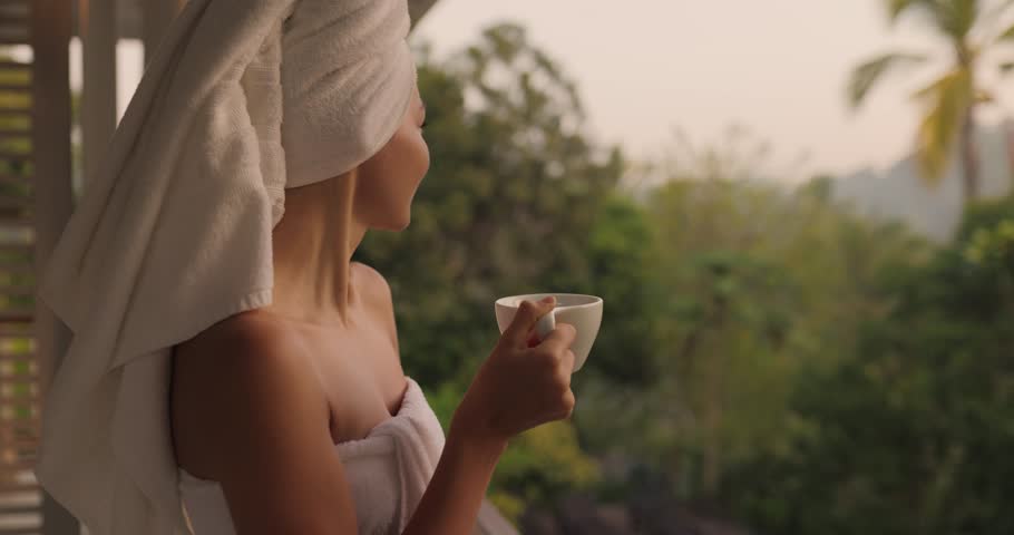 Woman With a Cup of Coffee After Shower on Open Resort Balcony Against Nature Background Royalty-Free Stock Footage #1103407361
