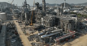 industrial plant construction project, crude oil and gas refinery new construction site large scale, aerial view drone shot, 4k video