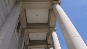 Columns at the Mississippi state Supreme Court building in Jackson, Mississippi with video tilting down.
