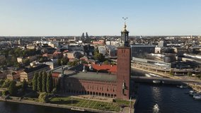 Aerial shot, of the tallest bell tower in the city, drone flying over the sea - Stockholm, Sweden - Powered by Shutterstock - Get 15% off with code: PIKWIZARD15