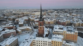 Aerial video at sunset over the Riddarholmen Church in the Old Town of Stockholm, Sweden
