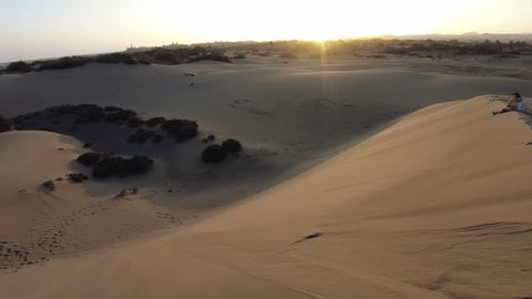 Maspalomas Dunes at sunset comprising of undulating sand dunes that extend for several miles, thus presenting a desert-like ambiance amidst the tropical Gran Canaria island. Stock video