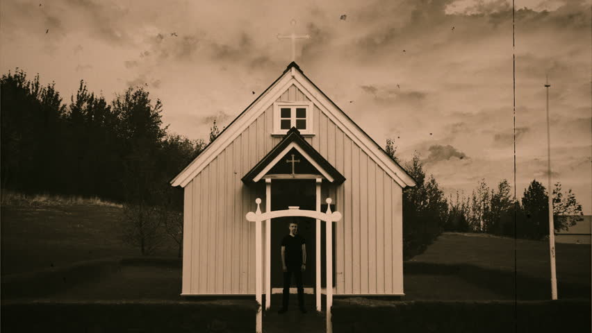 Old Church Religious Man Door Vintage Style Film Texture, Zoom In. Man looking watch in front of an old church house under a cloudy sky, sepia retro style. Zoom in