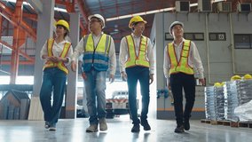 Group of Asian warehouse workers in safety uniform having discussion while walking through industry manufacturing factory. Factory warehouse concept - Powered by Shutterstock - Get 15% off with code: PIKWIZARD15