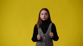 4k video of one young girl which respond negatively over yellow background.