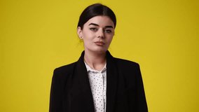 4k video of one girl who posing over yellow background.