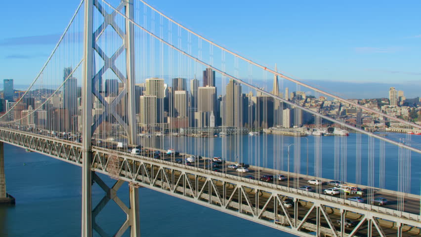 Amazing Aerial view of the San Francisco Oakland Bay Bridge During Rush Hour. Financial District skyline in the background. Interstate 80, California, US. Shot in 8K.