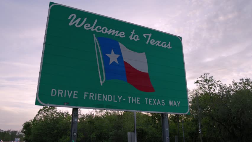 Welcome to Texas - drive friendly the Texas way sign on the state line with gimbal video stable. Royalty-Free Stock Footage #1103432431