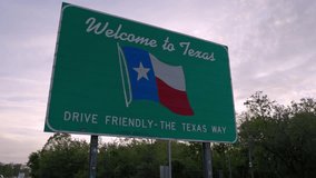 Welcome to Texas - drive friendly the Texas way sign on the state line with gimbal video stable.