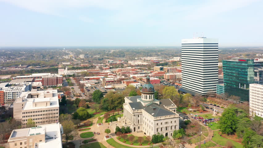 Aerial establishing shot of the South Carolina State House in Columbia and Columbia skyline. The South Carolina State House is the building housing the government of the U.S. state of South Carolina