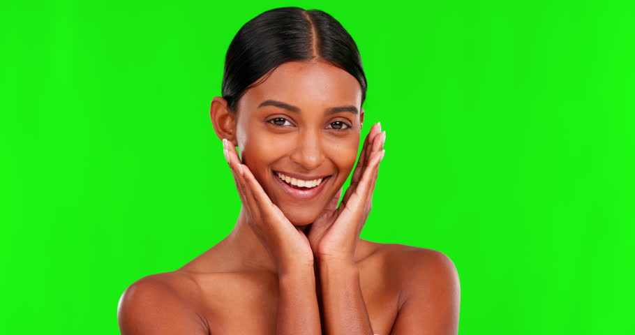 Beauty, skin and a woman touching her face on a green screen background in studio for skincare. Portrait, natural or antiaging treatment with a happy young female model marketing on chromakey mockup Royalty-Free Stock Footage #1103436515