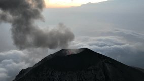 Volcán de Fuego erupting at sunset. Aerial drone video of volcanic eruption in Guatemala high above the clouds. - Powered by Shutterstock - Get 15% off with code: PIKWIZARD15