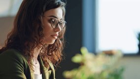 Attractive young girl office worker typing on laptop sitting modern cabinet close up. Focused elegant business woman working on desk computer indoors. Manager surfing internet searching information. - Powered by Shutterstock - Get 15% off with code: PIKWIZARD15