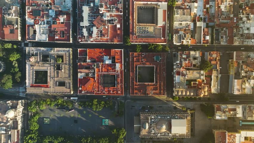Aerial view of typical buildings of Guadalajara cityscape. Example of famous residential urban grid in scenic gentle golden sunlight. Mexico aerial drone scenic latin city streets with red roofs 4K Royalty-Free Stock Footage #1103441587