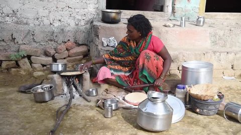 MAHARASHTRA, INDIA July 10, 2015: Rural women cooking front of her house, July 10, 2015, Salunkwadi, Ambajogai, Beed, Maharashtra, India