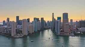 Aerial view of Miami, Florida at dusk, with slow forward camera motion. Miami is a majority-minority city and a major center and leader in finance, commerce, culture, arts, and international trade.
