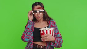 Excited happy woman in 3D glasses eating popcorn and watching interesting tv serial, sport game, film, online social media movie content. Hippie girl isolated on chroma key background, green screen