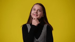 4k video of one girl is so excited about something over yellow background.