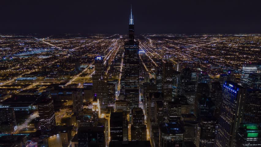 CHICAGO, USA - APRIL, 2023: Aerial drone timelapse of Chicago Downtown with skyscraper on cinematic background. Hyperlapse of financial and residential buildings cityscape view at night.