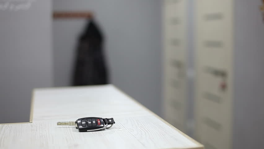 A man leaves the house, picks up a jacket from a hanger and the keys to the cars ignition. Royalty-Free Stock Footage #1103453865