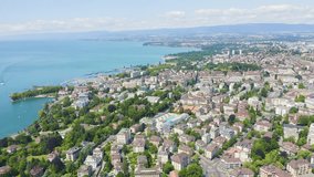 Inscription on video. Lausanne, Switzerland. Flight over the central part of the city. The coast of Lake Geneva. Text furry, Aerial View
