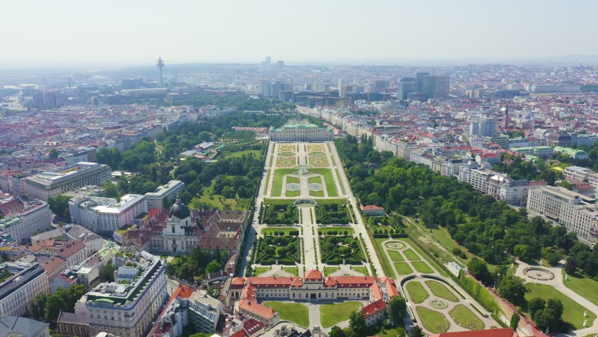 Inscription on video. Vienna, Austria. Baroque Belvedere Palace, a historic landmark with ornate facade, arises from serene blue garden waters. Aerial view