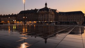 Iconic panorama of Place de la Bourse with tram and water mirror fountain in Bordeaux - France, Gironde. High quality 4k footage