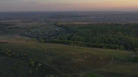 Aerial footage of an agricultural area and green rolling fields. Agronomic industry. Agrarian region of Ukraine, European Cinematic aerial shot. The beauty of the earth. Shot in 4k, drone video.
