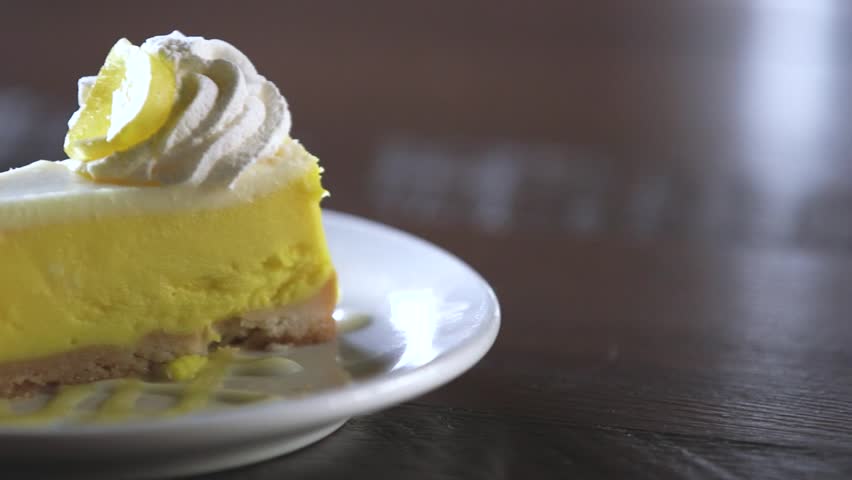 A slice of lemon pie skillfully presented on a plate.