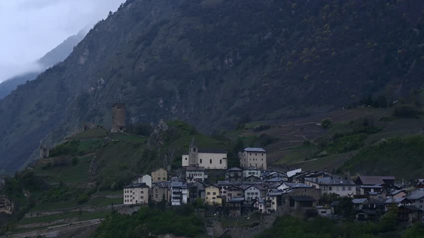 Famous historical Tourbillon Castle and Valere Basilica in the mountain with the village. Sion, Valais Canton, Switzerland. Real time.