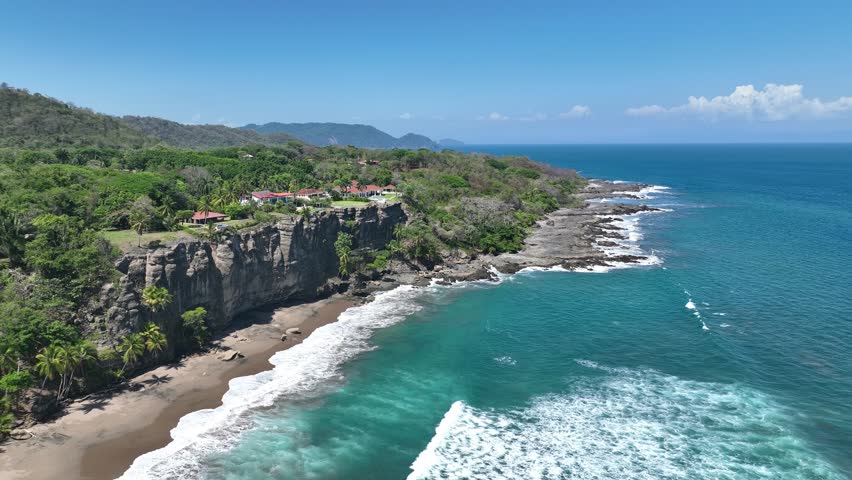 Experience ultimate luxury living in Tango Mar, Costa Rica, with stunning ocean view homes perched atop picturesque cliffs. Royalty-Free Stock Footage #1103470409
