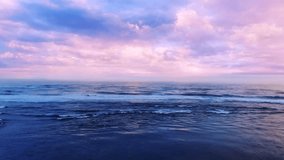Ocean beach sunrise 4k video, waves splash on the sea sand
